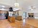 Traditional kitchen featuring wooden cabinets, a granite island, and a seamless transition into the adjacent living area at 318 Mitnik Dr, Deltona, FL 32738
