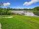 Picturesque lake view from the backyard with a small dock, great for relaxing at 318 Mitnik Dr, Deltona, FL 32738