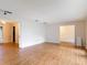 Open living room with wood-look flooring and multiple entryways to other rooms at 318 Mitnik Dr, Deltona, FL 32738