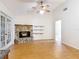 Bright living area showcasing a stone fireplace and access to an adjacent room, creating a cozy and versatile space at 318 Mitnik Dr, Deltona, FL 32738