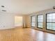 Living room showcasing the wood-look flooring, with windows and an adjacent room at 318 Mitnik Dr, Deltona, FL 32738