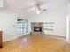 Inviting living room features a stone fireplace and sliding glass doors, perfect for relaxing and entertaining at 318 Mitnik Dr, Deltona, FL 32738