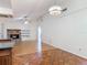 Open-concept living room featuring a stone fireplace, vaulted ceiling, and wood floors at 318 Mitnik Dr, Deltona, FL 32738