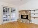 Cozy living room showcasing a stone fireplace and sliding doors that open to the outdoors at 318 Mitnik Dr, Deltona, FL 32738
