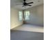 Neutral carpeted bedroom featuring two windows to allow for ample natural light at 910 Orchid St, Lady Lake, FL 32159