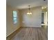 Cozy dining area featuring a chandelier and wood-look floors at 910 Orchid St, Lady Lake, FL 32159