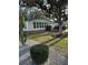 Charming single-story home featuring well-maintained landscaping and a blue accent roof at 910 Orchid St, Lady Lake, FL 32159