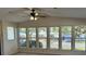 Bright living room with lots of natural light, a ceiling fan, and wood-look floors at 910 Orchid St, Lady Lake, FL 32159