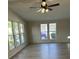 Bright living room with lots of natural light, a ceiling fan, and wood-look floors at 910 Orchid St, Lady Lake, FL 32159