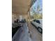 Carport area with cars and a door to a backyard at 5195 Edwina St, Orlando, FL 32811