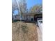 Modest single-story home with covered parking and a front porch amidst trees at 5195 Edwina St, Orlando, FL 32811