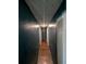 Narrow hallway with wood flooring and blue painted walls at 5195 Edwina St, Orlando, FL 32811