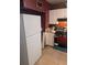 Kitchen with white cabinets, refrigerator, and gas range at 5195 Edwina St, Orlando, FL 32811