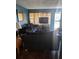 Cozy living room featuring a comfortable dark couch and a television at 5195 Edwina St, Orlando, FL 32811