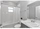 Well-lit bathroom featuring a shower-tub combo, sleek sink, and convenient vanity with ample storage at 11331 Sw 54Th Cir, Ocala, FL 34476