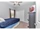 Cozy bedroom featuring a ceiling fan, closet, and dresser for ample storage at 11331 Sw 54Th Cir, Ocala, FL 34476