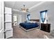 Comfortable bedroom with a tray ceiling, a ceiling fan, and an access to a private balcony at 11331 Sw 54Th Cir, Ocala, FL 34476