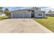 Charming single-story home with a spacious driveway and attached two-car garage at 11331 Sw 54Th Cir, Ocala, FL 34476