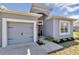 Charming home featuring a well-manicured lawn, attached garage, and inviting front entrance at 11331 Sw 54Th Cir, Ocala, FL 34476