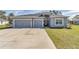 Charming home with a well-manicured lawn and a spacious three-car garage at 11331 Sw 54Th Cir, Ocala, FL 34476