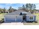 Charming home with a well-manicured lawn and a spacious three-car garage at 11331 Sw 54Th Cir, Ocala, FL 34476