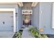 Inviting front entrance with a decorative glass door and well-maintained landscaping at 11331 Sw 54Th Cir, Ocala, FL 34476
