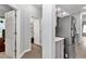 Hallway featuring access to the refrigerator, utility room, and backyard at 11331 Sw 54Th Cir, Ocala, FL 34476