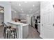Inviting open-concept kitchen with bar seating, gray cabinets, and stainless steel appliances at 11331 Sw 54Th Cir, Ocala, FL 34476