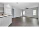 Open-concept living area featuring hardwood floors, neutral walls, and ample natural light, great for comfortable living at 11331 Sw 54Th Cir, Ocala, FL 34476