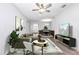 Comfortable living room with hardwood floors, stylish furniture, a ceiling fan, and a dining area, perfect for relaxing at 11331 Sw 54Th Cir, Ocala, FL 34476