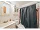 Modest bathroom with pink accent tiles, basic fixtures, and a shower with curtain at 1222 Avenue M, Haines City, FL 33844