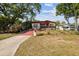 Charming single-story home featuring a well-maintained front yard and a red-colored driveway at 1222 Avenue M, Haines City, FL 33844