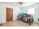 A bare room featuring a door, window, tile floor, and hospital bed frame at 1222 Avenue M, Haines City, FL 33844