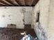 Basement view showing cinder block walls, damaged floors covered in debris, and an exposed ceiling at 1075 Merritt St, Altamonte Springs, FL 32701