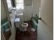 Dated bathroom with white tile, a green tub and toilet with some damage at 1075 Merritt St, Altamonte Springs, FL 32701