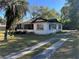 Exterior of a quaint home with a screened-in porch, showcasing the front yard and driveway at 1075 Merritt St, Altamonte Springs, FL 32701