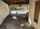 Interior of a dilapidated two car garage filled with leaves, trash, and damaged fixtures at 1075 Merritt St, Altamonte Springs, FL 32701
