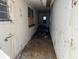 Hallway showing disrepair with damaged walls, debris-covered floors, and boarded windows at 1075 Merritt St, Altamonte Springs, FL 32701