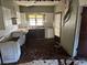 Damaged kitchen with outdated cabinets, flooring issues and peeling walls at 1075 Merritt St, Altamonte Springs, FL 32701