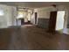 Interior view of a derelict home with damaged walls, exposed floors, and open access to the kitchen at 1075 Merritt St, Altamonte Springs, FL 32701