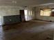 Interior view of a derelict living room, showing damaged walls, floor, and debris scattered throughout at 1075 Merritt St, Altamonte Springs, FL 32701