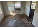 Interior view of a room in disrepair, featuring damaged flooring, peeling walls, and a boarded window at 1075 Merritt St, Altamonte Springs, FL 32701