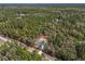 Aerial view showcasing the home nestled within a lush, green landscape at 5593 Sw 199Th Ct, Dunnellon, FL 34431