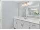 Bright bathroom featuring a white vanity with a marble countertop and a large mirror at 5593 Sw 199Th Ct, Dunnellon, FL 34431