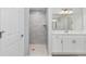 Updated bathroom with a gray tiled shower and a modern vanity with white marble countertop at 5593 Sw 199Th Ct, Dunnellon, FL 34431