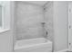 Clean and bright tiled shower and tub combination with new fixtures and a built-in shelf at 5593 Sw 199Th Ct, Dunnellon, FL 34431