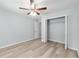 Bedroom with light wood floors, closet, and natural light creating a comfortable atmosphere at 5593 Sw 199Th Ct, Dunnellon, FL 34431