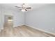 Bright bedroom with wood-look flooring, ceiling fan and a sliding glass door at 5593 Sw 199Th Ct, Dunnellon, FL 34431