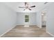 Unfurnished bedroom with a ceiling fan, wood-look floors, and an ensuite bathroom at 5593 Sw 199Th Ct, Dunnellon, FL 34431