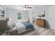 Comfortable bedroom with a ceiling fan, light-colored walls, and wood-look flooring at 5593 Sw 199Th Ct, Dunnellon, FL 34431